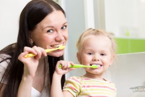 mom and child brushing teeth beckermeyer dds dentist niles mi